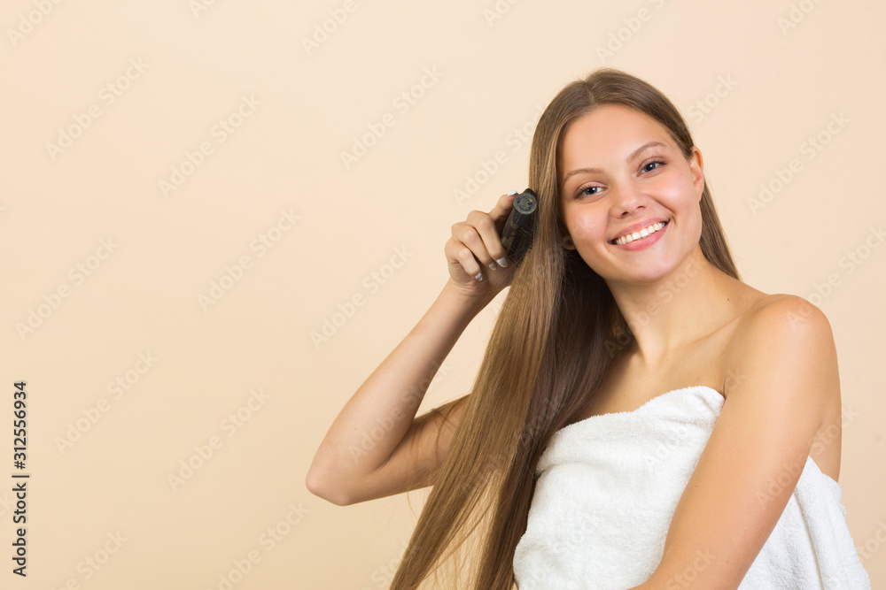 beautiful young woman with long flowing hair on a beige background beautiful young woman with long flowing hair on a beige background