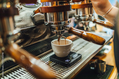 View on coffee making process in coffee shop, black coffee in cup. 