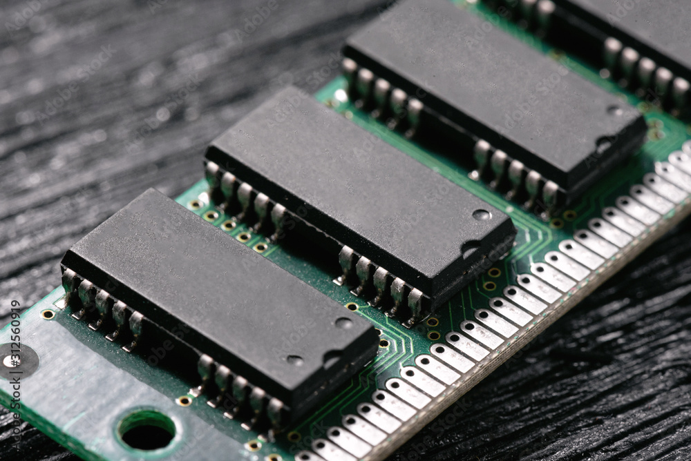 Old computer ram memory module on black wooden background. Old computer ram memory module on black wooden background.