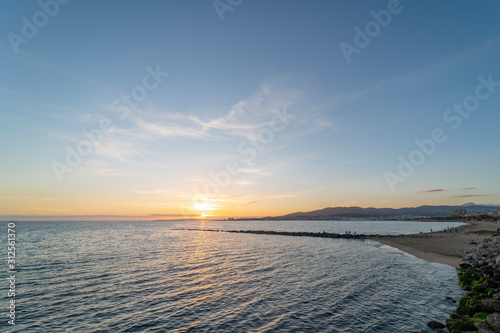 Can Pere Antoni  mediterranean beach panorama at sunset  in the Palma city promenade  Majorca  Spain. A stone pier in the background and beautiful seafront.