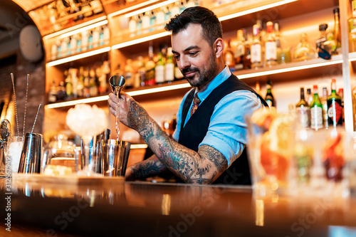 Professional young bartender working photo