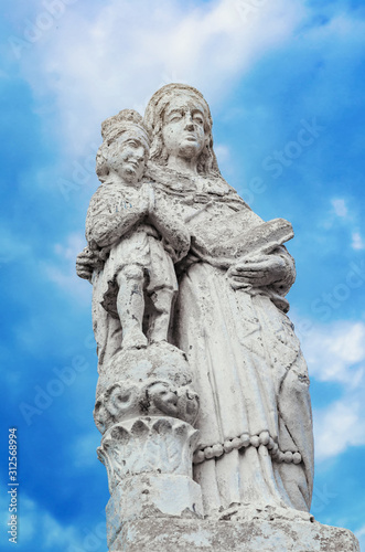 Ancient christian statue on blue sky background