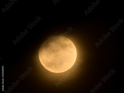 Full moon behind the clouds