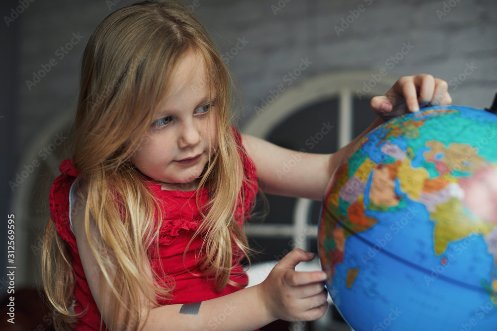 Child looking at a globe Child looking at a globe