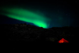 Glowing polar lights above camping tent
