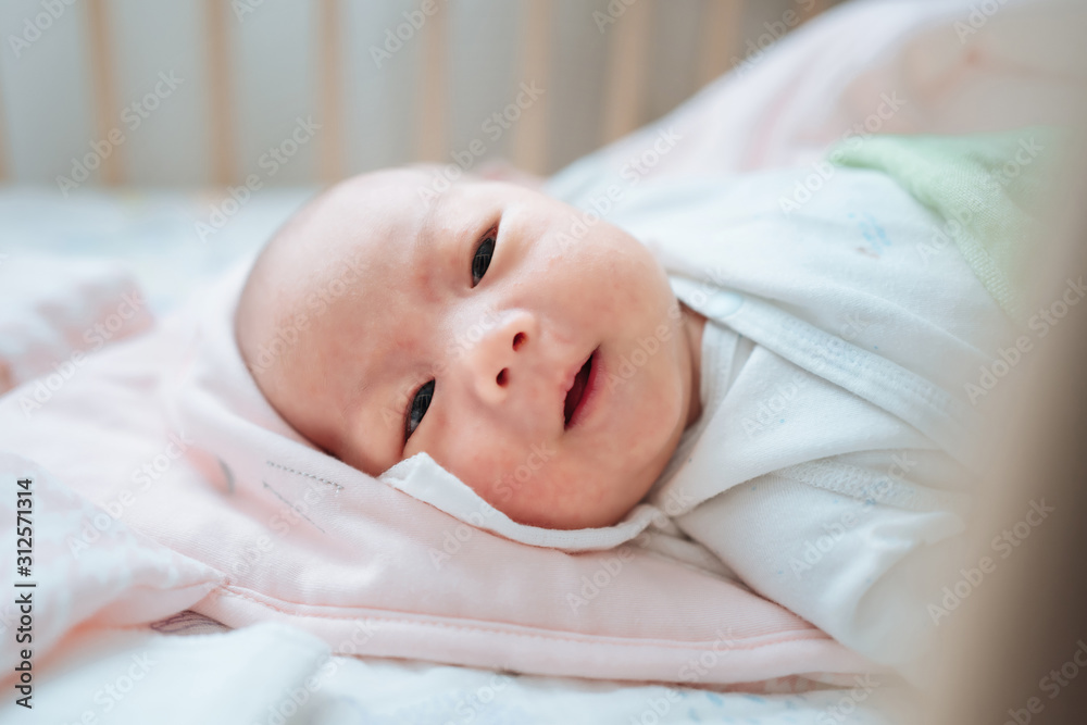 Newborn playing in the small bed in the bedroom Newborn playing in the small bed in the bedroom