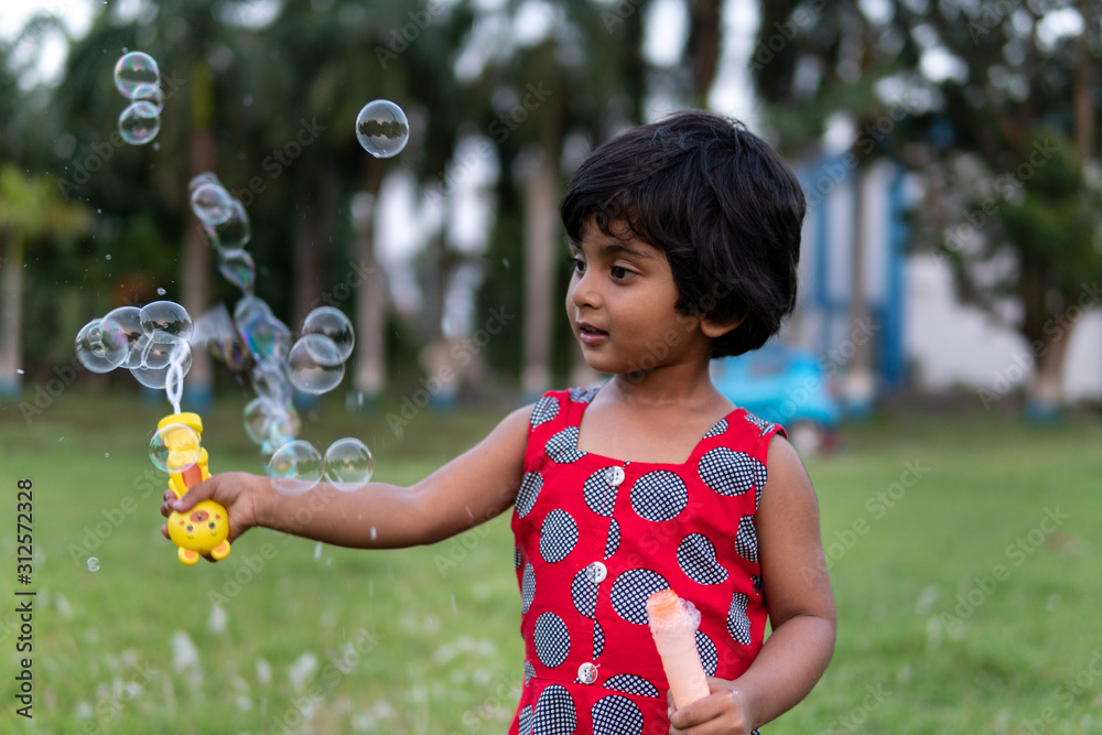 Cute girl playing and making fun with soap bubbles Cute girl playing and making fun with soap bubbles