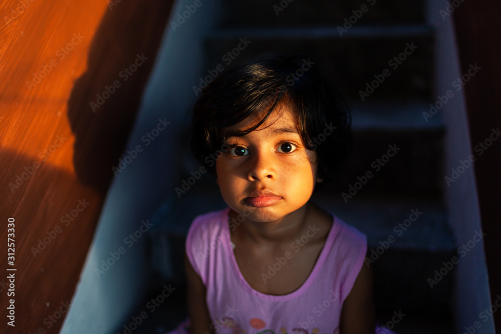 Little girl making a sad face in sunset light Little girl making a sad face in sunset light