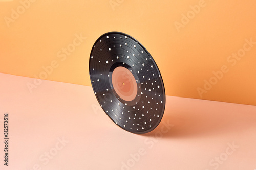 Vintage vinyl record with white dots on a duotone background.