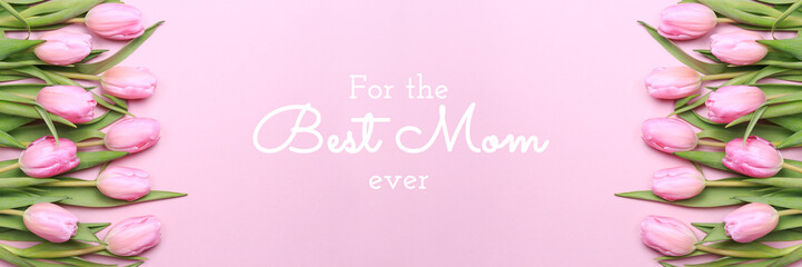For the best Mom ever wording with pink tulips on the pink background. Flat lay, top view. Mother's day holiday celebration card. Horizontal, banner format