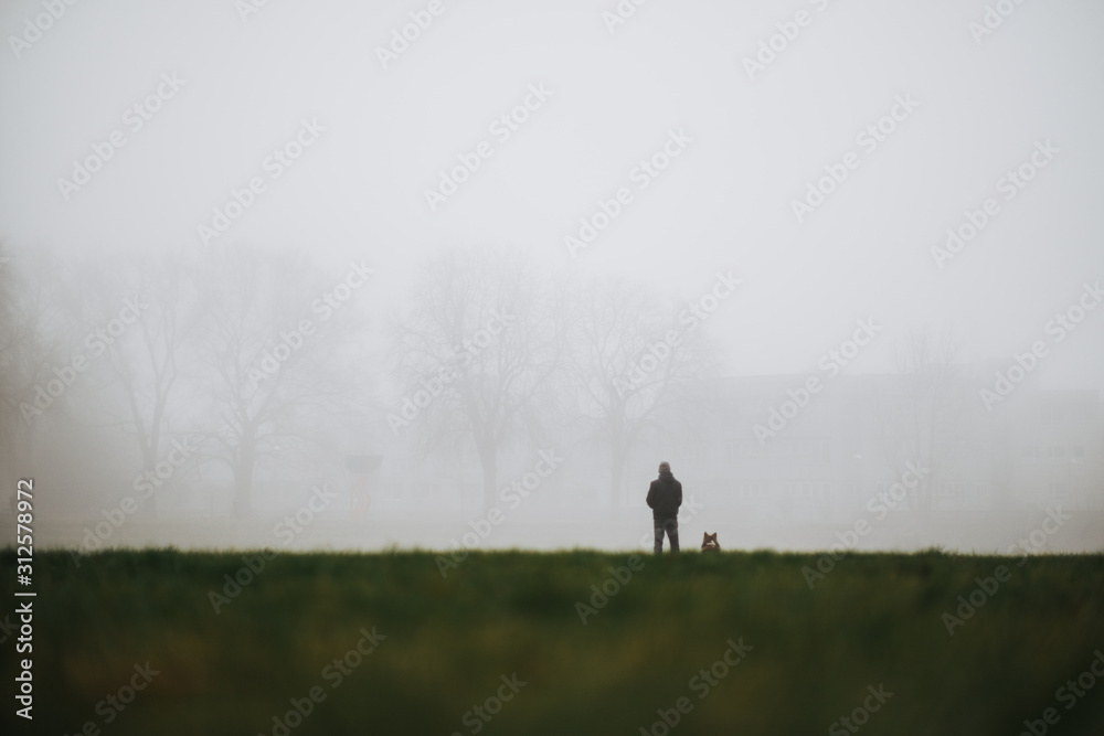 man and his dog as symbol of deep friendship in fog