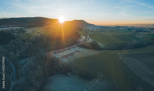 Aerial, panoramic view of a country road in a rural area at sunset, Essingen, Germany photo