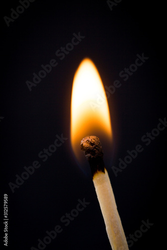 Lighting matches at the moment when it explodes. Burning match over black background. Close up. Copy space.