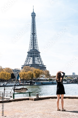 Woman taking a picture of the Eiffel Tower © Kira McDermid