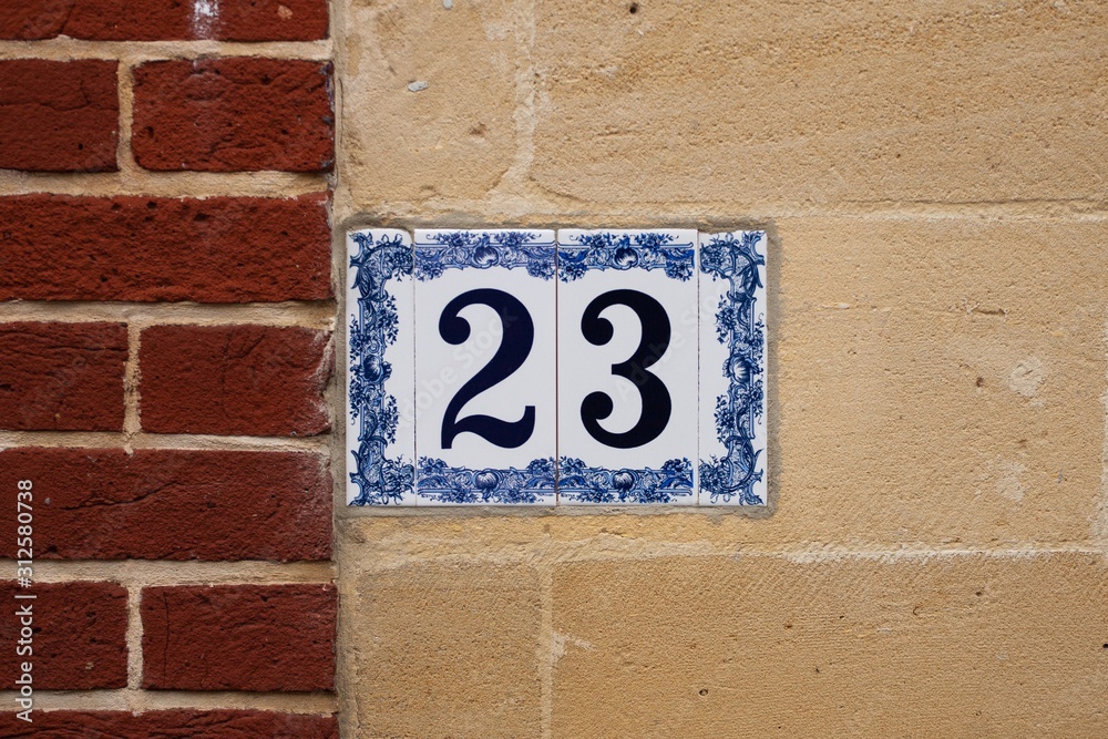 number 23 ceramic tile house number sign on brick wall number 23 ceramic tile house number sign on brick wall