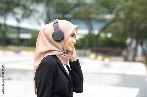 Hijab businesswoman wear headphone with business concept.