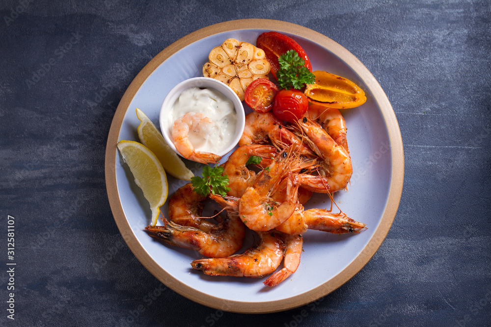 Shrimps with sauce, lemon and vegetables. Seafood. View from above, top Shrimps with sauce, lemon and vegetables. Seafood. View from above, top