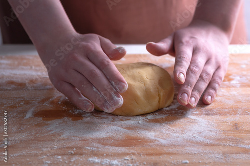 A cook is preparing a cookie dough. Shortbread dough for cookies. photo