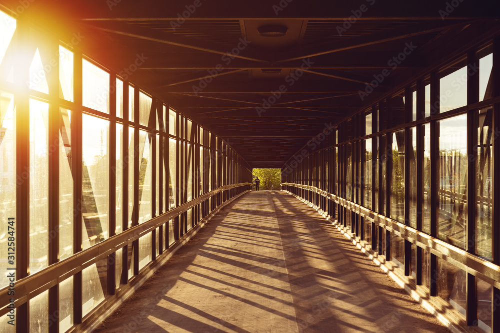 pedestrian pathway above highway, golden light shining creating shadows, strong light coming from side pedestrian pathway above highway, golden light shining creating shadows, strong light coming from side