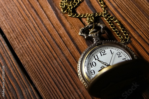 pocket watch on a wooden background