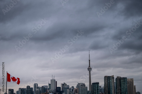 The Canadian flag in front of Toronto skyline