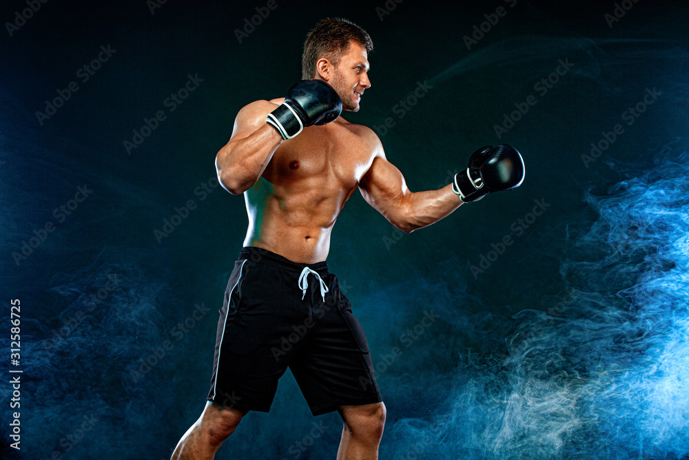 Fitness and boxing concept. Boxer, man fighting or posing in gloves on dark background. Individual sports recreation.