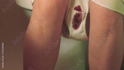 Woman smear underpants with menstrual blood. Menstrual cycle. Woman health care
