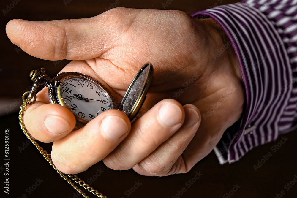 a pocket watch in the hands of a man a pocket watch in the hands of a man