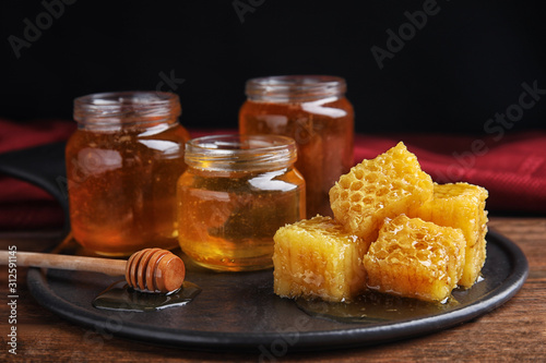 Composition with fresh delicious honey on wooden table