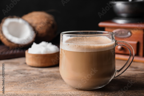 Delicious coffee with organic coconut oil on wooden table