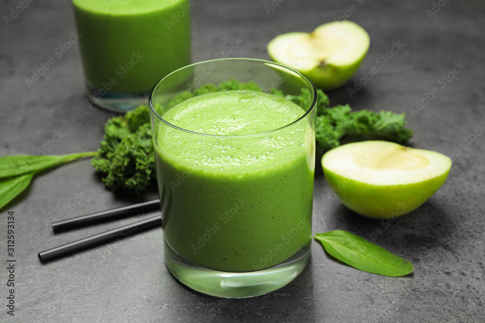 Tasty fresh kale smoothie on grey table, closeup Tasty fresh kale smoothie on grey table, closeup