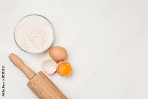 Flat lay composition with raw eggs on white table, space for text. Baking pie