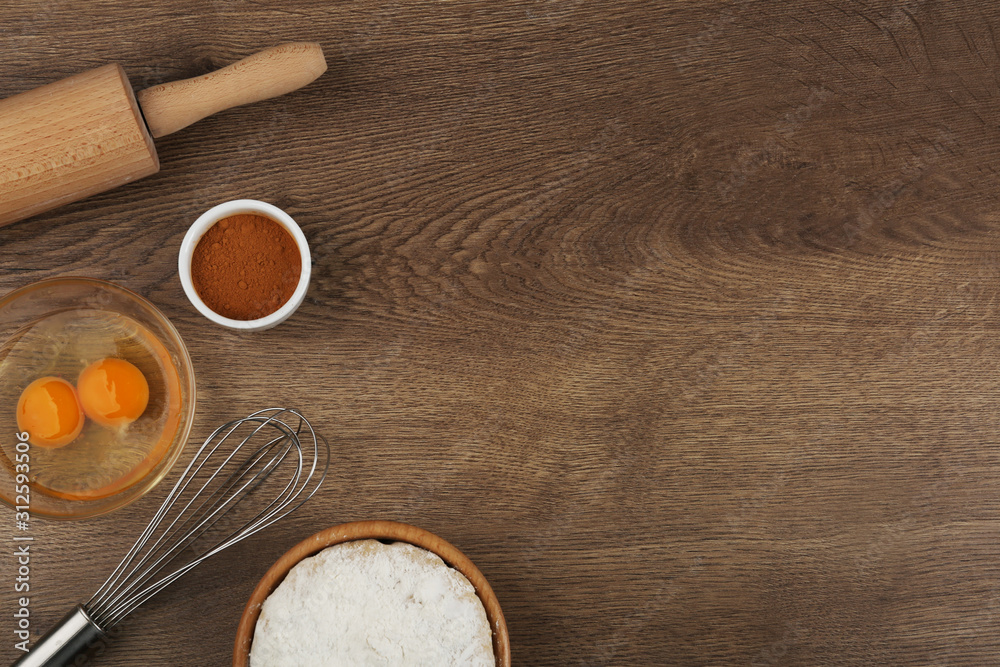 Flat lay composition with raw eggs and other ingredients on wooden table, space for text. Baking pie Flat lay composition with raw eggs and other ingredients on wooden table, space for text. Baking pie