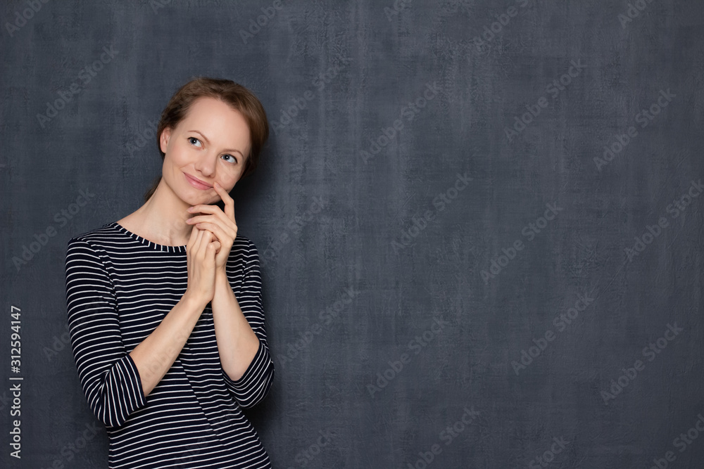Portrait of happy thoughtful young woman touching face with hand Portrait of happy thoughtful young woman touching face with hand