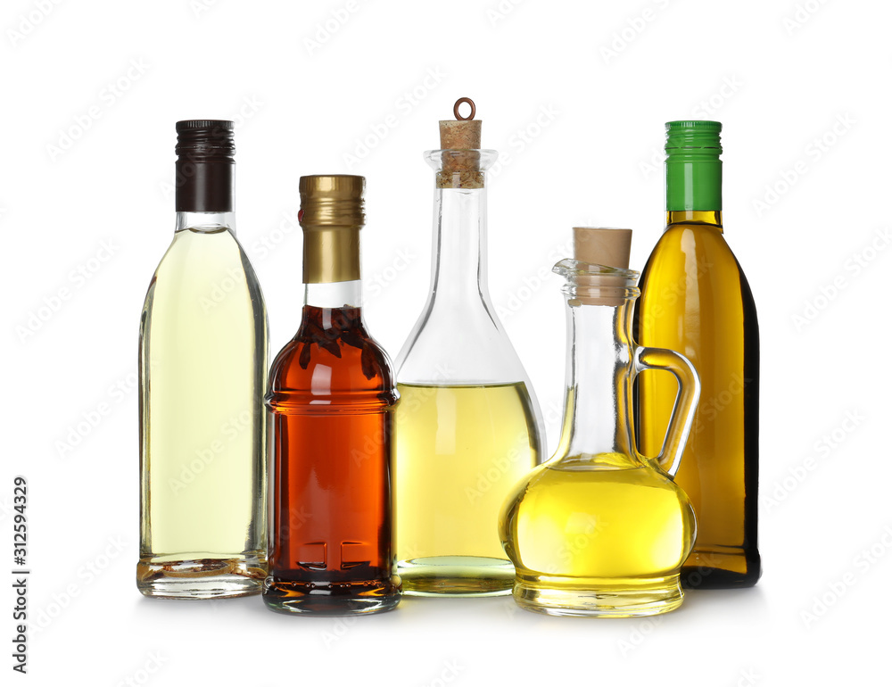 Different sorts of cooking oil in bottles isolated on white