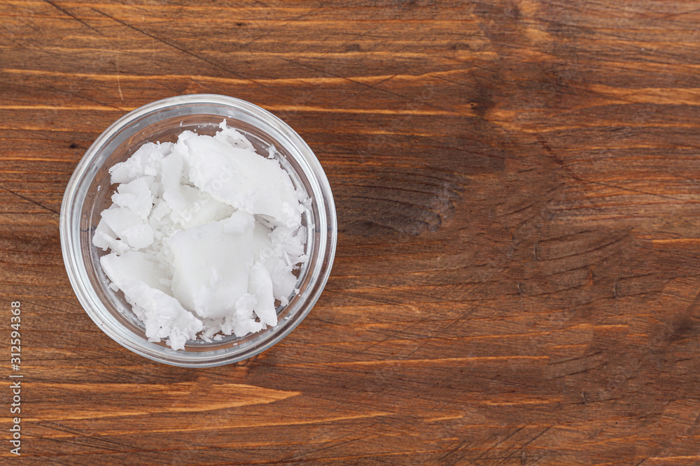 Organic coconut oil in bowl on wooden table, top view with space for text. Healthy cooking Organic coconut oil in bowl on wooden table, top view with space for text. Healthy cooking
