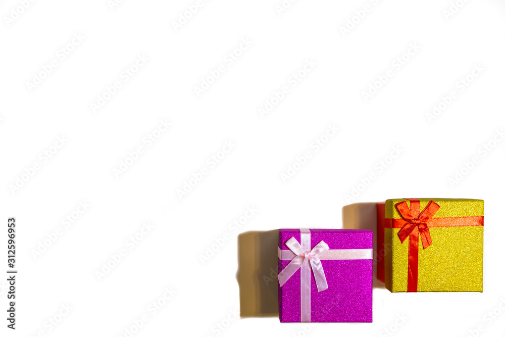 Fototapeta premium 2019.12.29, Moscow, Russia. Two bright gift boxes with red ribbon on a white background. Concept of Happy birthday or another festival.