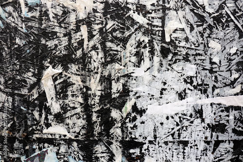 Black and white grungy backgroud. Old surface of leftovers from posters. Black and white grungy backgroud. Old surface of leftovers from posters.