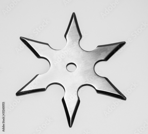Silver shuriken with star shape isolated on white background.