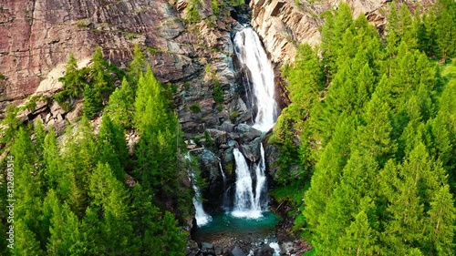 amazing big waterfall filmed by drone backward fly photo