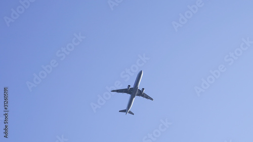 plane in clear blue sky. flying passenger plane in clear blue. air transport traveling by plane