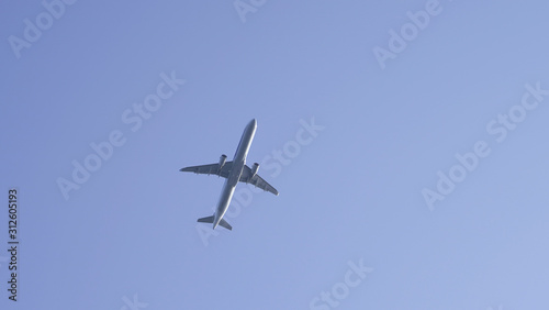 plane in clear blue sky. flying passenger plane in clear blue. air transport traveling by plane