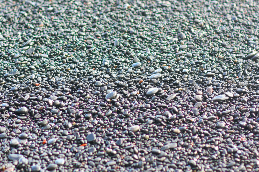 Pebble stones closeup on the shore in the blurry background Pebble stones closeup on the shore in the blurry background