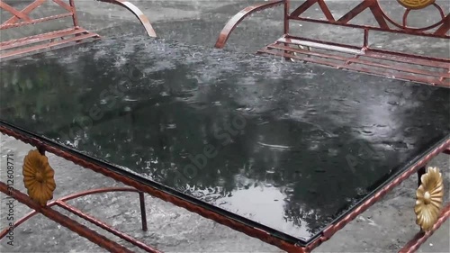 Rain drops on top of glass table with rain backsound photo