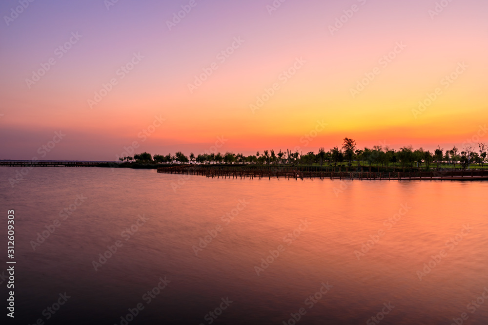 Dreamy sunset landscape by the lake