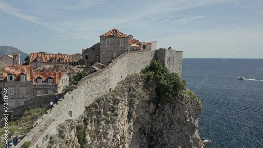 The old town of Dubrovnik, Croatia along the Adriatic sea with fortified walls along cliff edge. The old town of Dubrovnik, Croatia along the Adriatic sea with fortified walls along cliff edge.