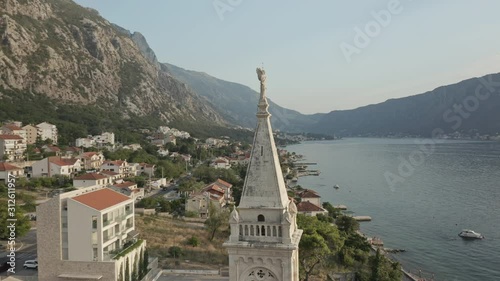 A small village overlooking the Bay of Kotor in Montenegro. Wide shot rotation around the Church of Saint Eustace. photo