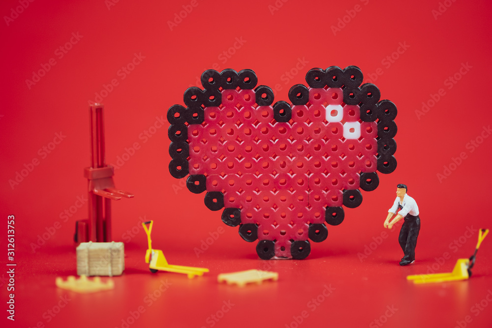 Miniature people : Worker team create Valentine's Day postcard.