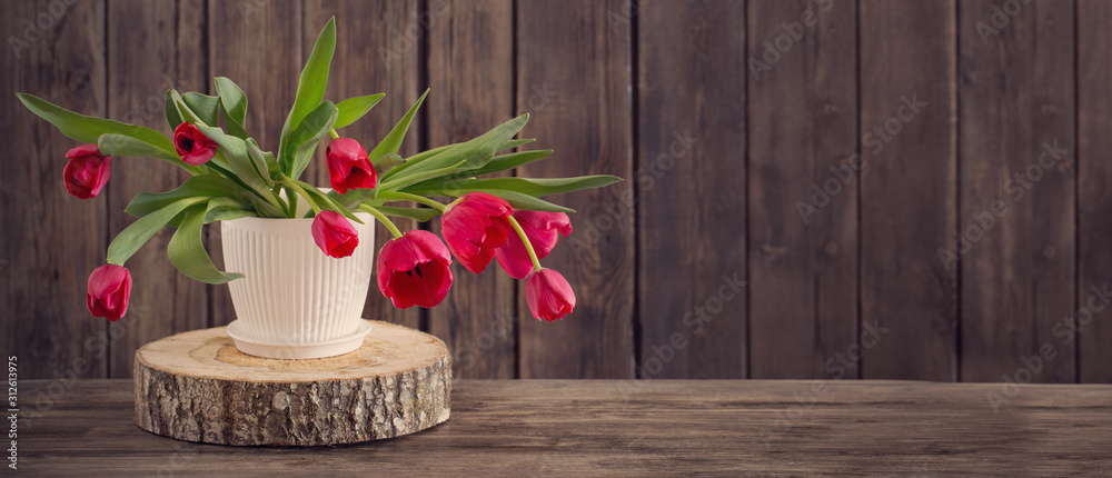 bouquet of red tulips on wooden background