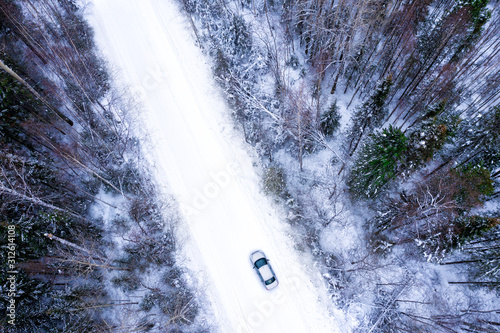 Top view on winter forest and car road